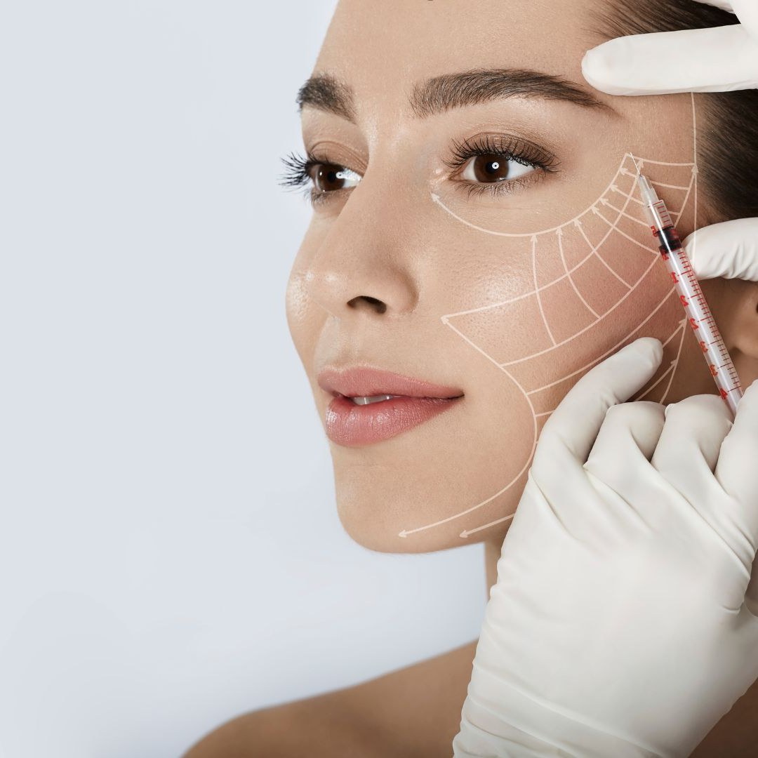 Aesthetics professional with facial treatment markings